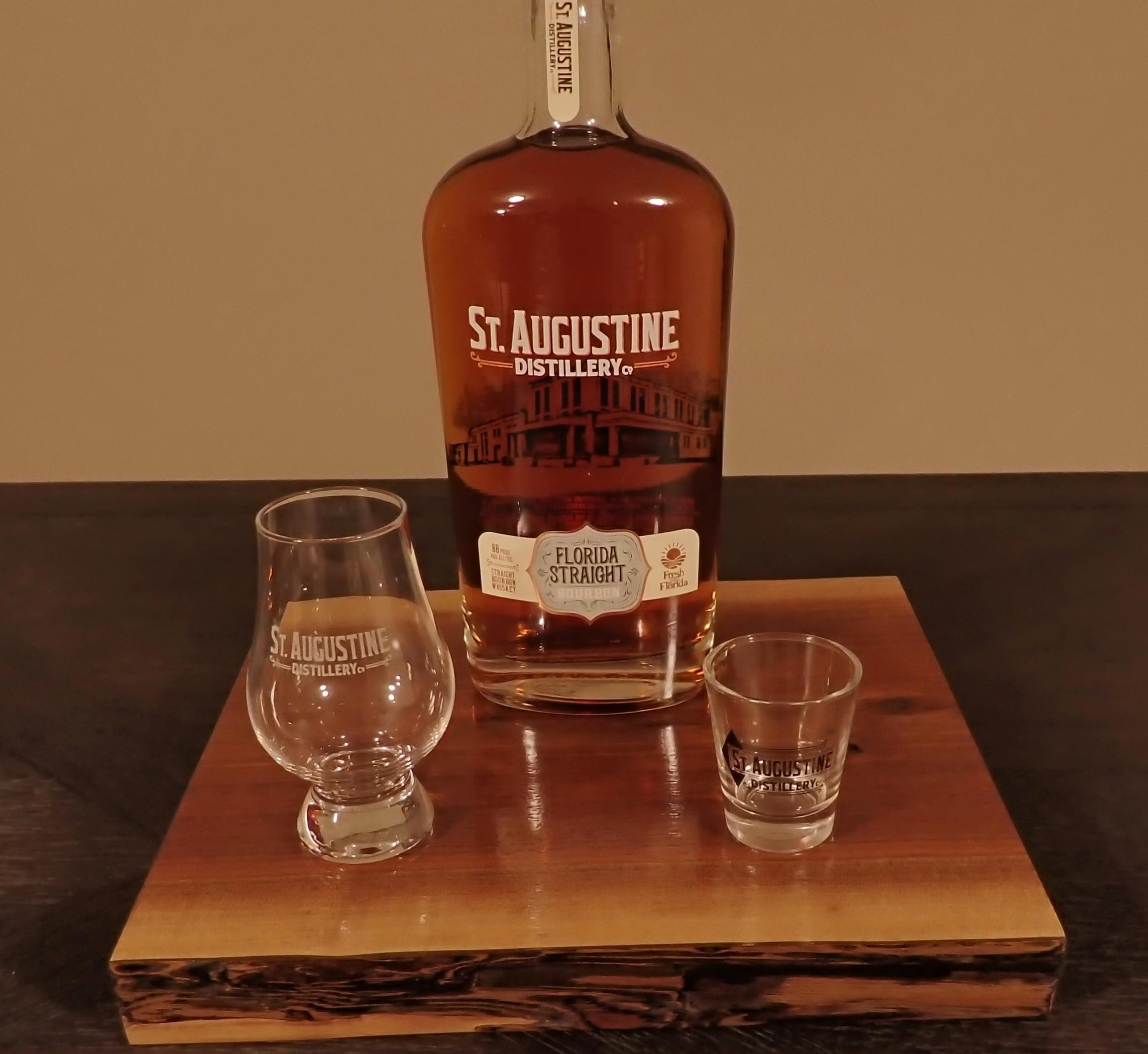 board with bottle and 2 glasses